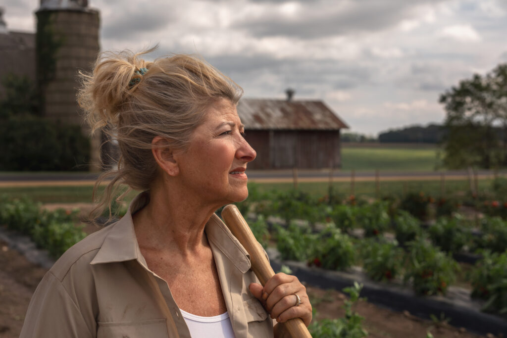 Older blonde woman looking out over field
