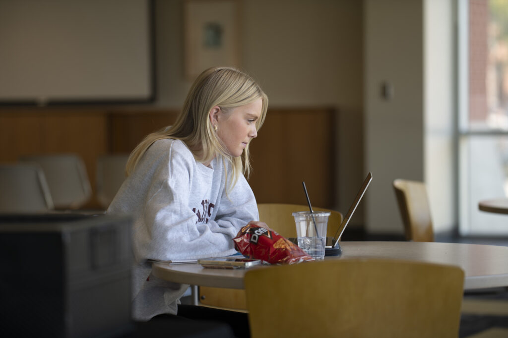 College student looking intently at laptop